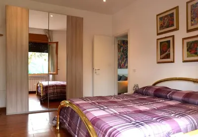 a bedroom with a bed and a living room at Casa di Alberta in Rome