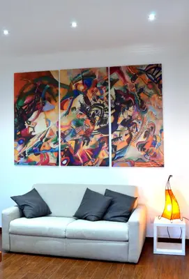 a living room with four paintings on the wall at Casa di Alberta in Rome