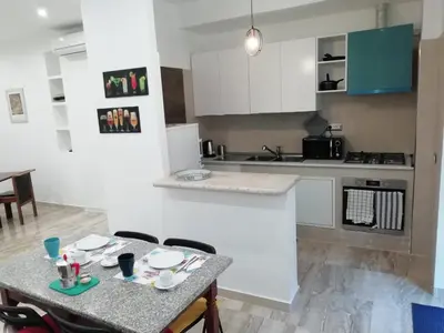 a kitchen with a table and chairs and a counter at Rita a Trastevere in Rome