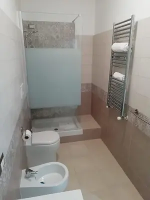 a small bathroom with a toilet and a sink at Rita a Trastevere in Rome