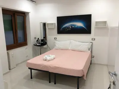 a bedroom with a bed with a pink blanket at Rita a Trastevere in Rome