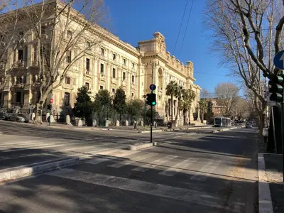 an empty street in front of a large building at Rita a Trastevere in Rome