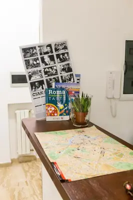 a table with a map on it with photos on it at Rita a Trastevere in Rome