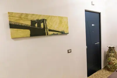 a painting of a bridge on a wall next to a door at Rita a Trastevere in Rome