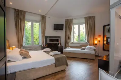 a bedroom with two beds and a fireplace at Vatican Suites - The Luxury Leading Accommodation in Rome in Rome