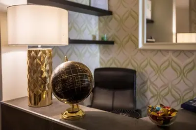 a desk with a lamp and a ball on a table at Vatican Suites - The Luxury Leading Accommodation in Rome in Rome