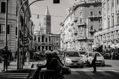 a black and white photo of a city street with cars at Vatican Suites - The Luxury Leading Accommodation in Rome in Rome