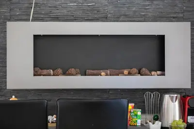a fireplace with rocks on a wall at Vatican Suites - The Luxury Leading Accommodation in Rome in Rome
