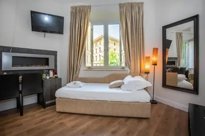 a bedroom with a bed and a large window at Vatican Suites - The Luxury Leading Accommodation in Rome in Rome