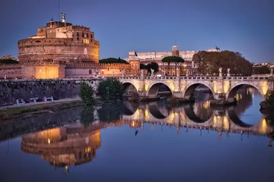 a bridge over a river with a castle at Vatican Suites - The Luxury Leading Accommodation in Rome in Rome