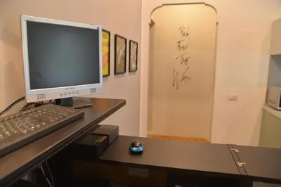 a computer monitor and a keyboard and mouse on a desk at All You Need is Rome Guesthouse in Rome