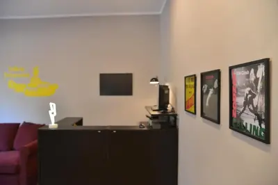 a living room with a couch and pictures on the wall at All You Need is Rome Guesthouse in Rome