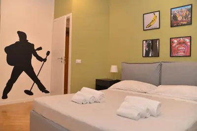 a bedroom with a bed with a baseball player on the wall at All You Need is Rome Guesthouse in Rome
