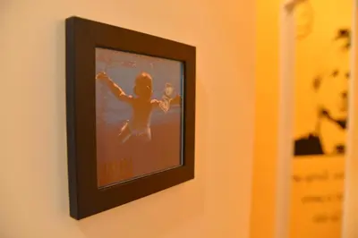 a framed picture of a girl in the water on a wall at All You Need is Rome Guesthouse in Rome