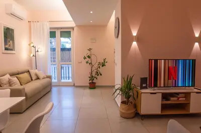 a living room with a couch and a tv at La Casupola - Gemelli Garden in Rome