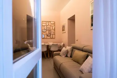 a living room with a couch and a table at La Casupola - Gemelli Garden in Rome