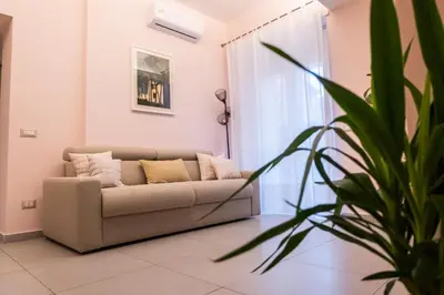 a living room with a couch and a plant at La Casupola - Gemelli Garden in Rome
