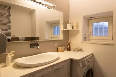 a bathroom with a sink and a washing machine at La Casupola - Gemelli Garden in Rome