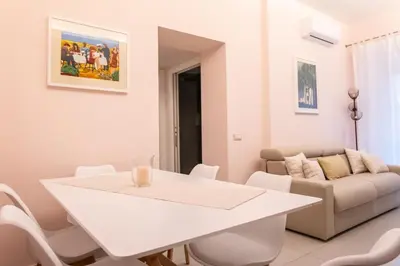 a white dining room with a white table and chairs at La Casupola - Gemelli Garden in Rome