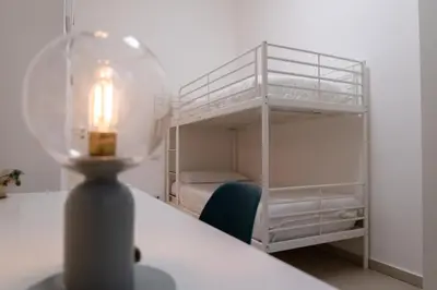 a bedroom with a bunk bed with a light on a table at La Casupola - Gemelli Garden in Rome