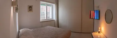 a small bedroom with a bed and a window at La Casupola - Gemelli Garden in Rome