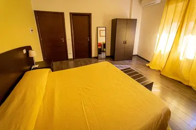 a bedroom with a yellow bed with a yellow blanket at Difronte Ai Musei Vaticani in Rome