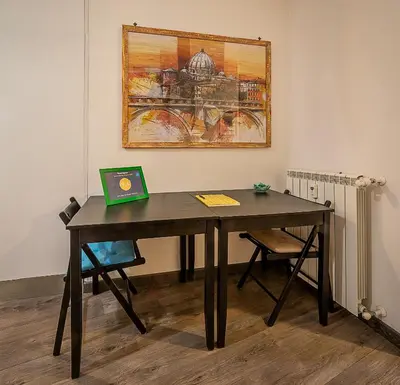 a table with a book on it in a room at Difronte Ai Musei Vaticani in Rome