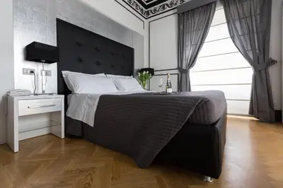 a bedroom with a large bed with a black headboard at Residenza Scipioni Luxury B&B in Rome