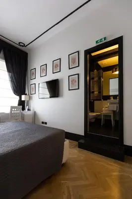 a bedroom with a large bed and a mirror at Residenza Scipioni Luxury B&B in Rome