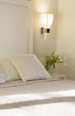 a bedroom with a bed with a light on the wall at Residenza Scipioni Luxury B&B in Rome