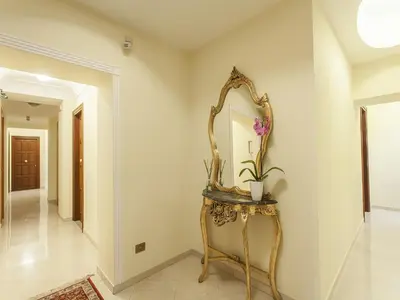 a hallway with a mirror and a console table at Hotel Regina Giovanna in Rome