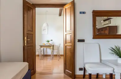 a room with a door and a table with a chair at Torripa Group - Trastevere in Rome