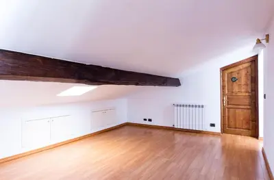 an empty room with a wooden floor and a wooden door at Torripa Group - Trastevere in Rome