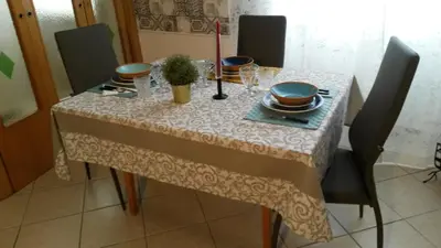 a dining room table with a table cloth on it at Casa SereTina in Rome