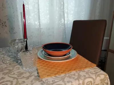 an orange bowl on a plate on a table at Casa SereTina in Rome