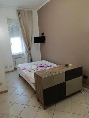 a bedroom with a bed and a table in it at Casa SereTina in Rome