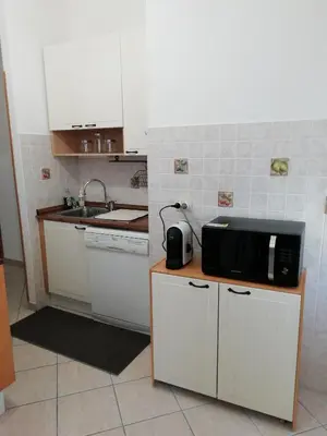 a small kitchen with a microwave on a counter at Casa SereTina in Rome
