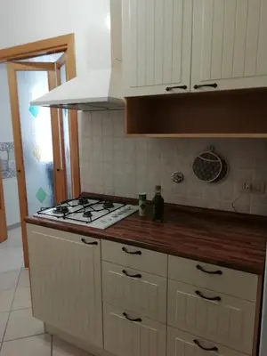 a kitchen with a stove and white cabinets at Casa SereTina in Rome