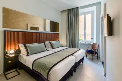 a bedroom with a large bed in a room at Adrianus Hotel in Rome