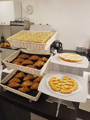 a kitchen with several trays of pies and pastries at Adrianus Hotel in Rome