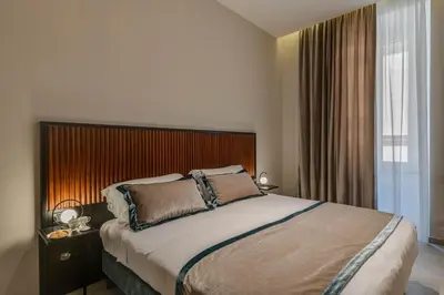 a bedroom with a large bed and a window at Adrianus Hotel in Rome