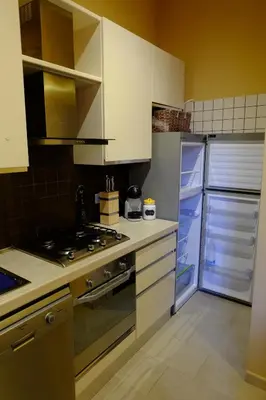 a kitchen with a stove and a refrigerator at Villa Ella in Rome