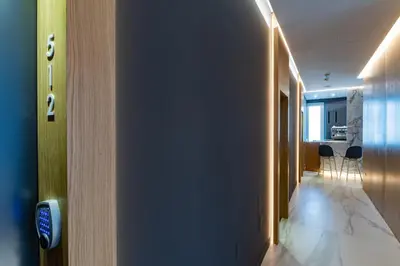 a hallway with a room with a kitchen and some chairs at Concept Terrace Hotel in Rome
