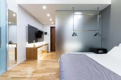a bedroom with a bed and a desk and a television at Concept Terrace Hotel in Rome