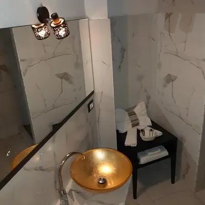 a bathroom with a gold sink and a mirror at Popolo Relax in Rome