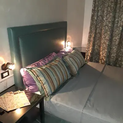 a bed with two pillows on it next to a table at Popolo Relax in Rome
