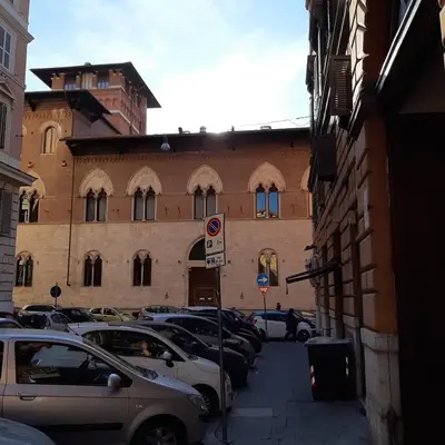 a street with cars parked in front of a building at Popolo Relax in Rome