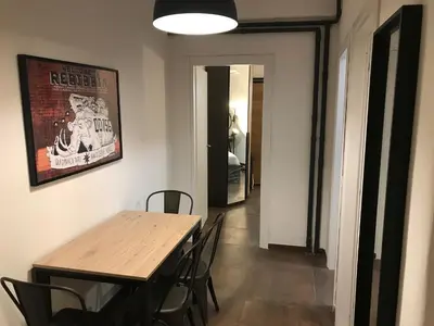 a dining room with a wooden table and chairs at Appartamento in via Licia in Rome