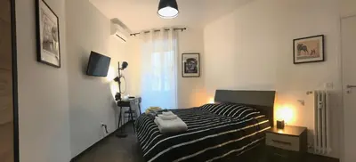 a bedroom with a black and white striped bed at Appartamento in via Licia in Rome