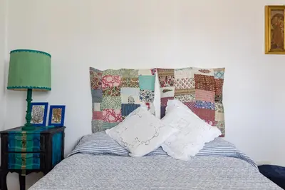 a bedroom with a bed with pillows and a headboard at Rome Top floor with Terrace in Rome